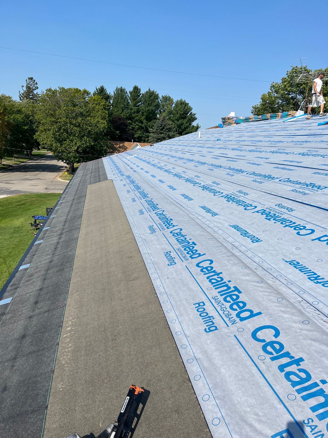 a roof is being covered with a certain brand roofing material