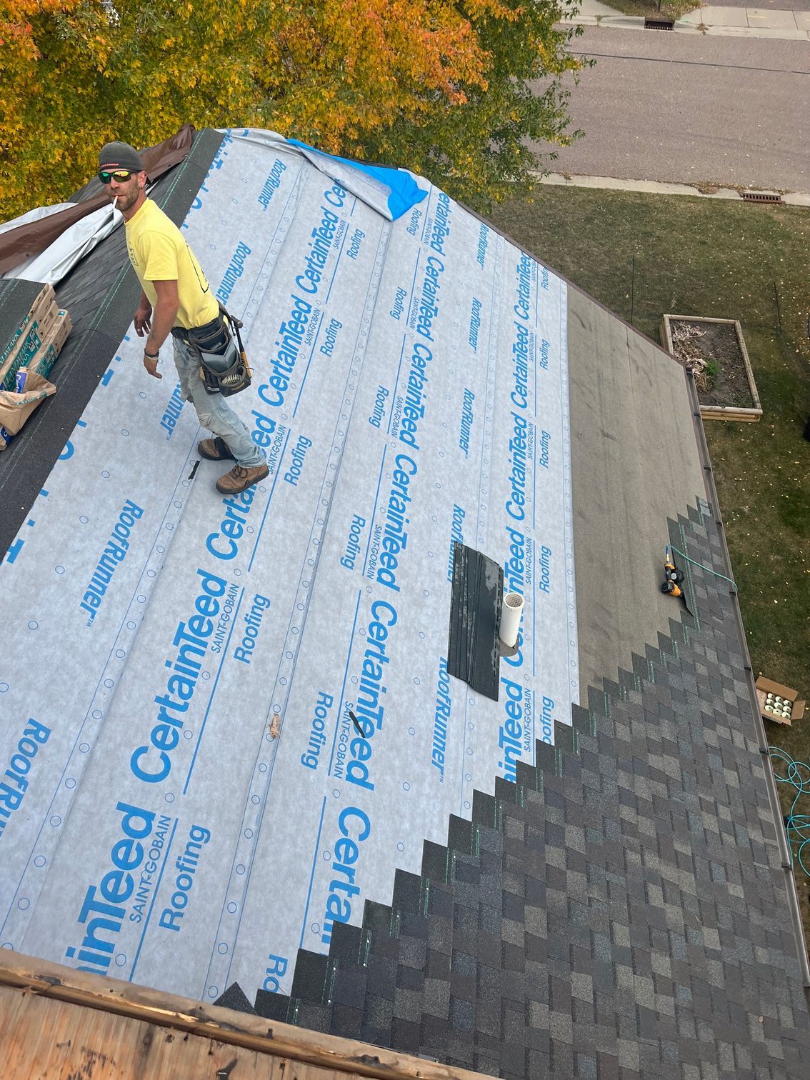 a man is working on the roof of a house