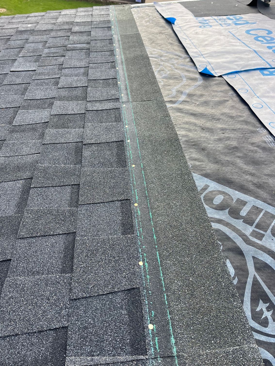 a close up of a roof with shingles being installed