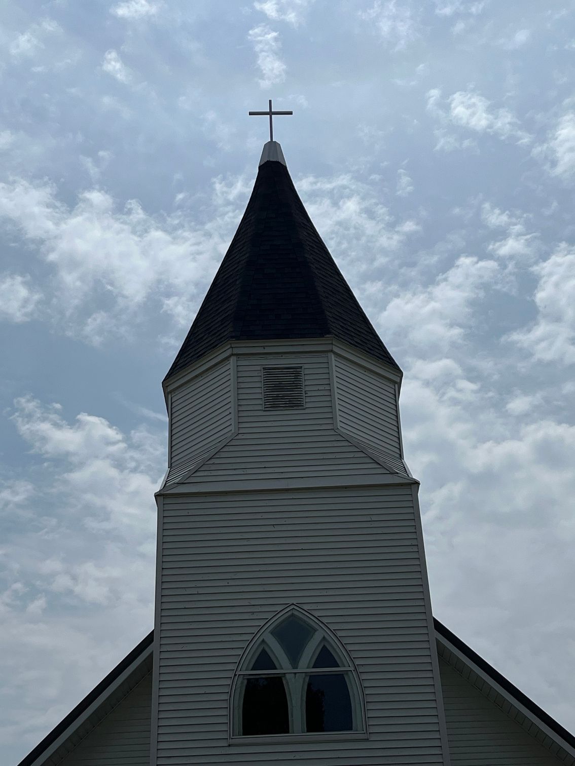 a church steeple with a cross on top of it