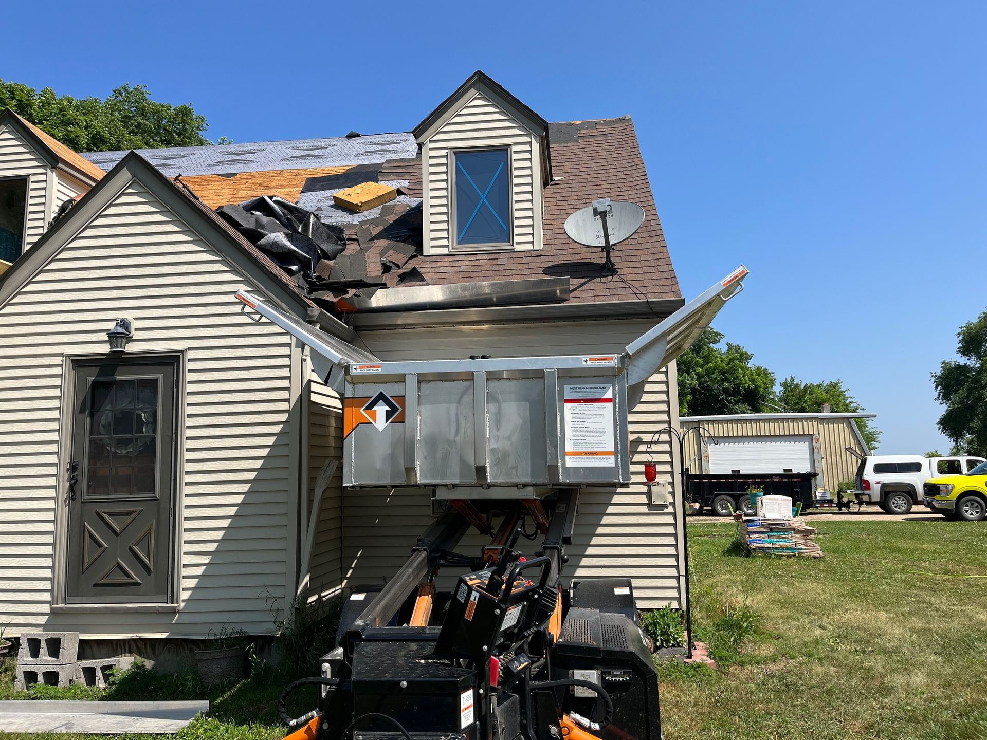 a house with a satellite dish on the roof is being remodeled