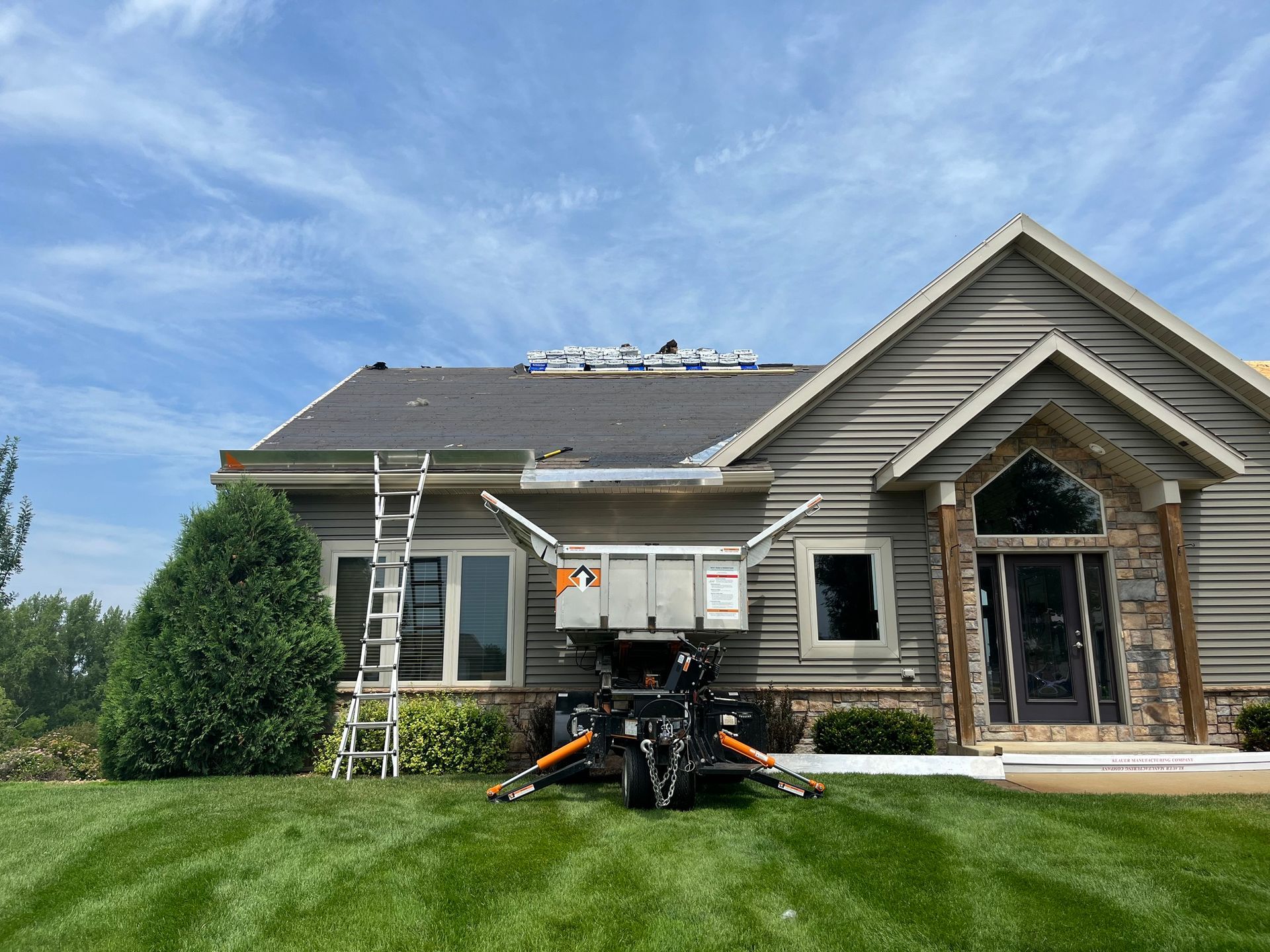 a house with a dumpster in front of it