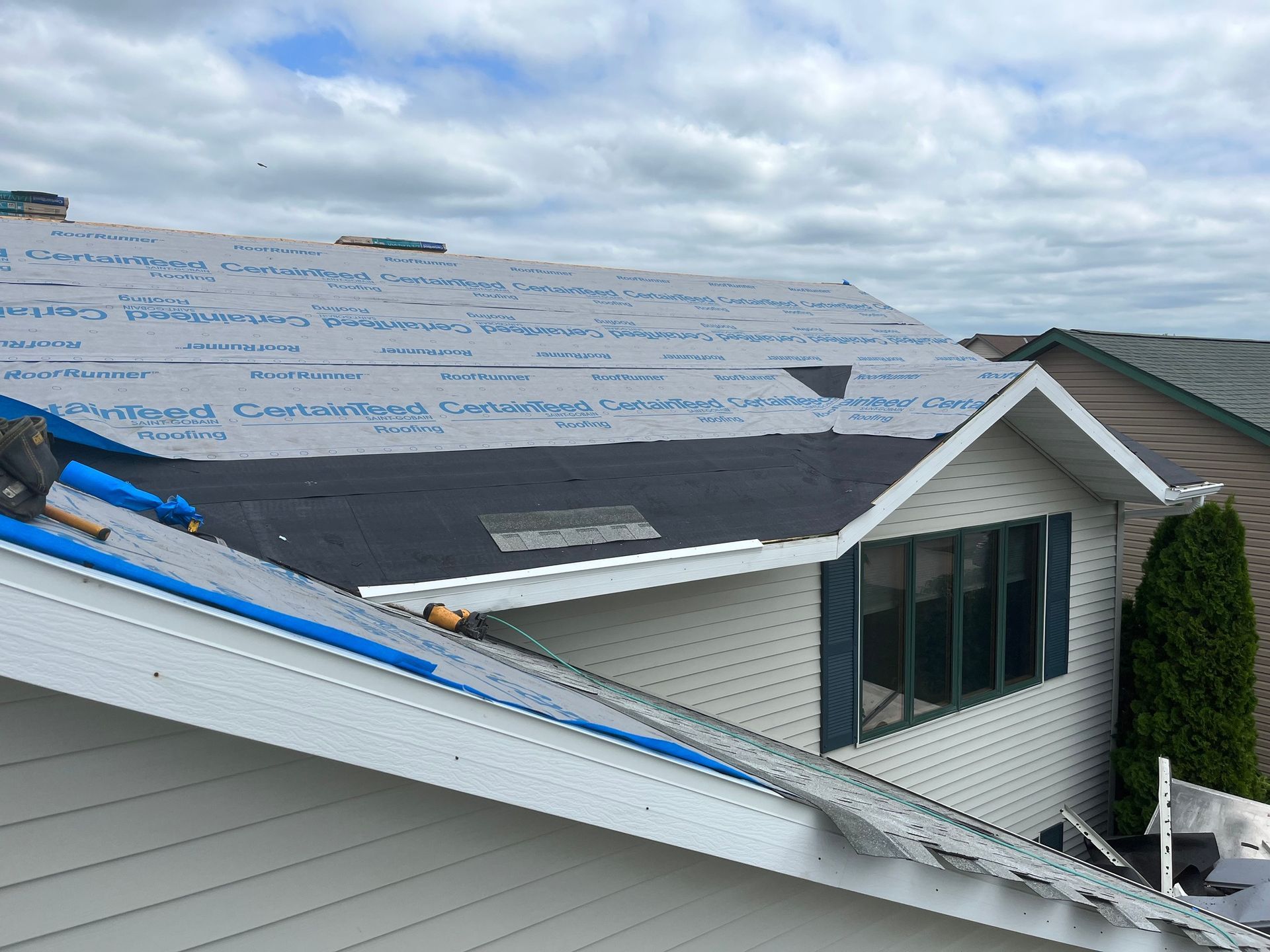 a man is working on the roof of a house