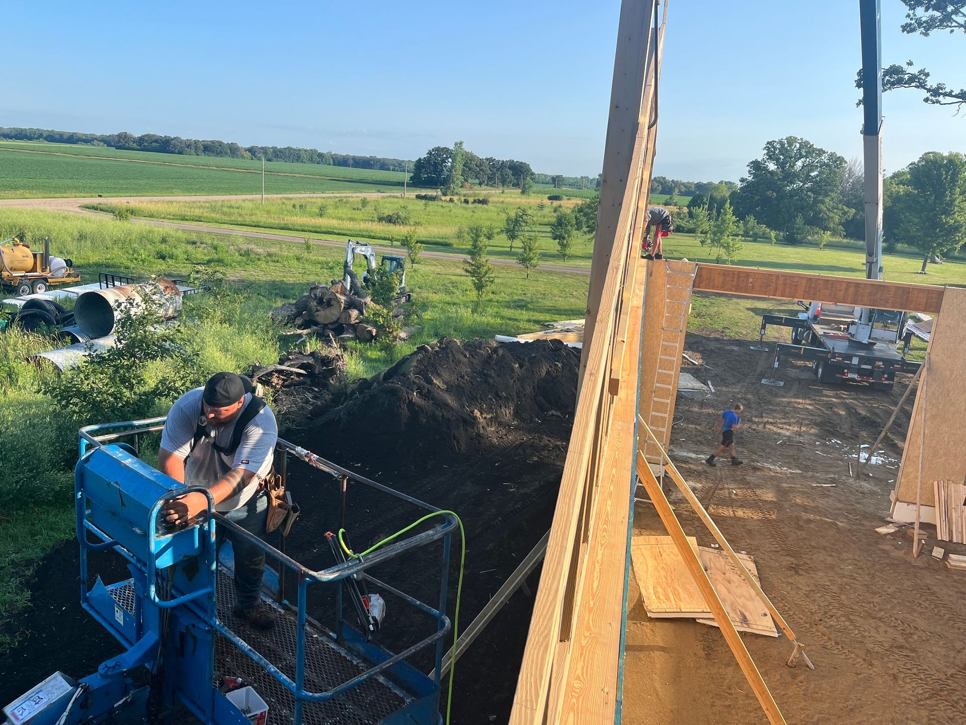 a man is standing in a lift on top of a construction site