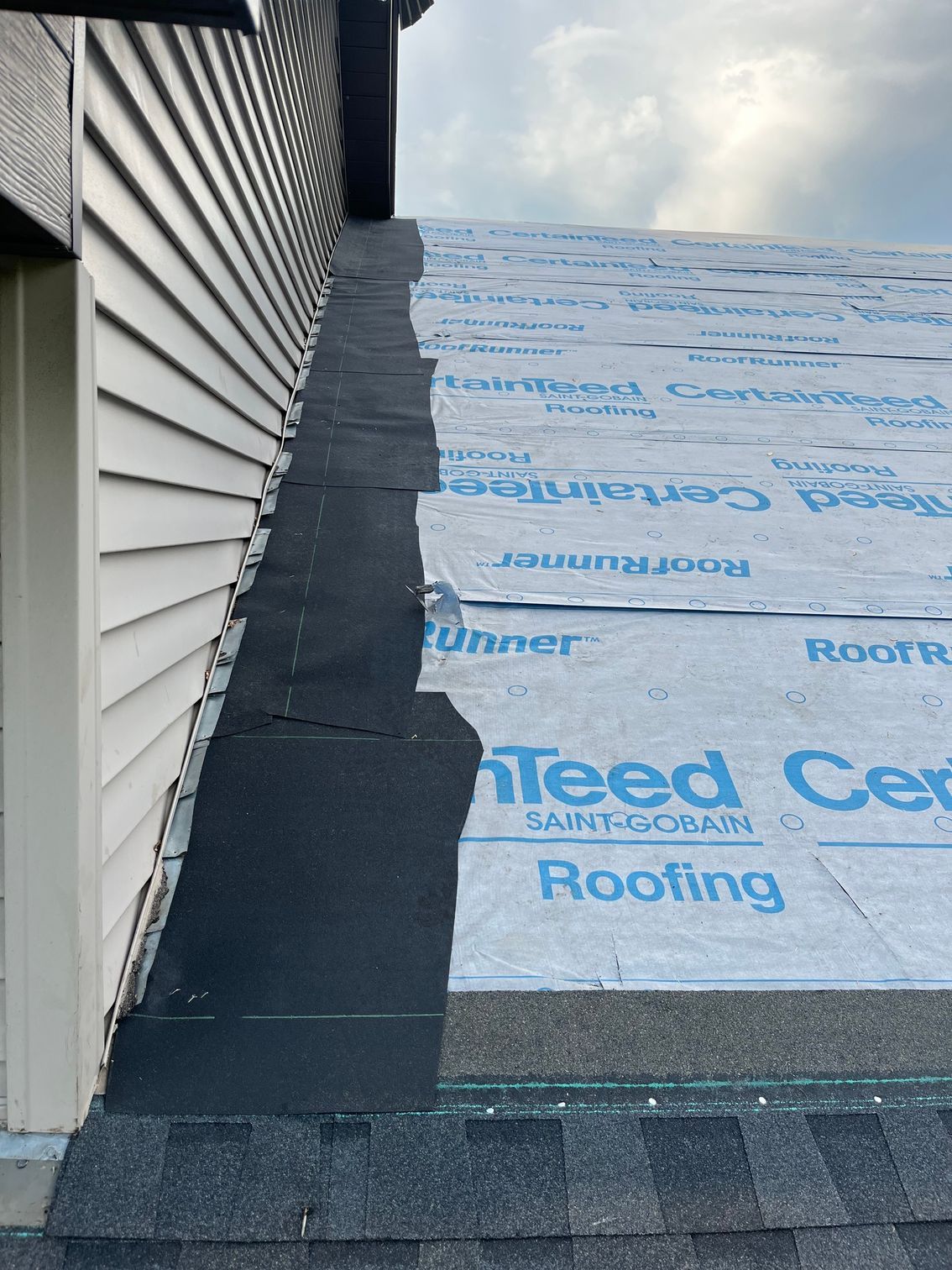 a house with a roof that is being covered in shingles