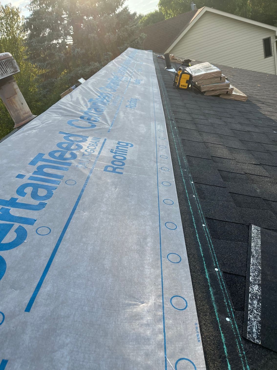 the roof of a house is being covered with a tarp