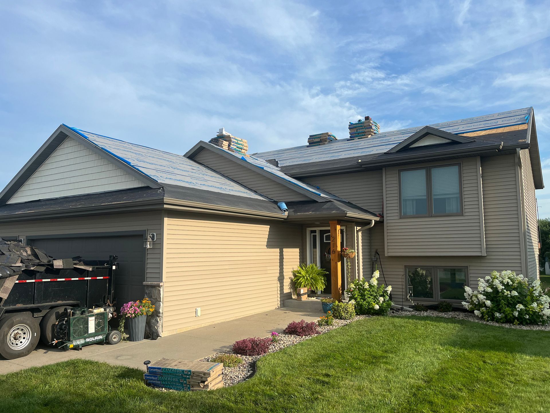 a large house with a metal roof and a truck parked in front of it