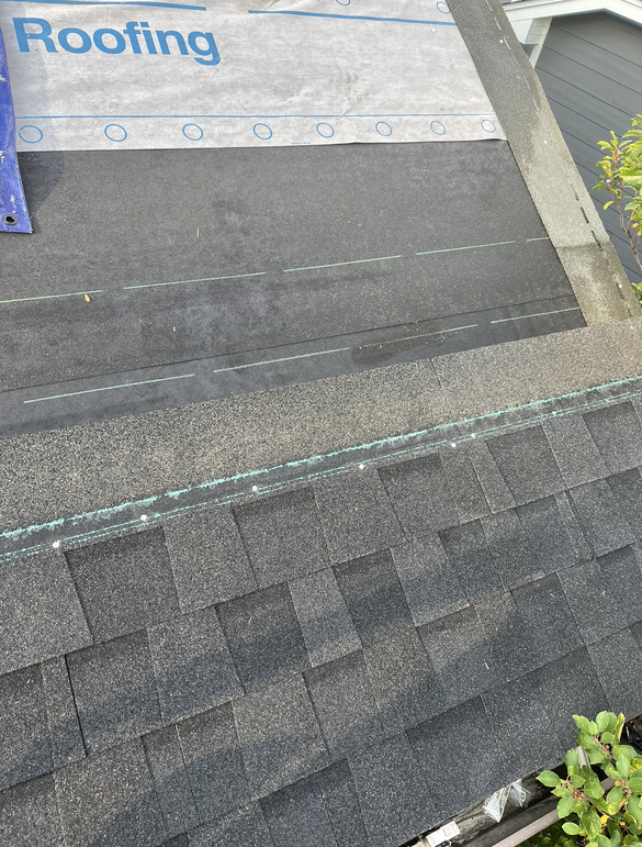 a roof with shingles and a piece of roofing paper