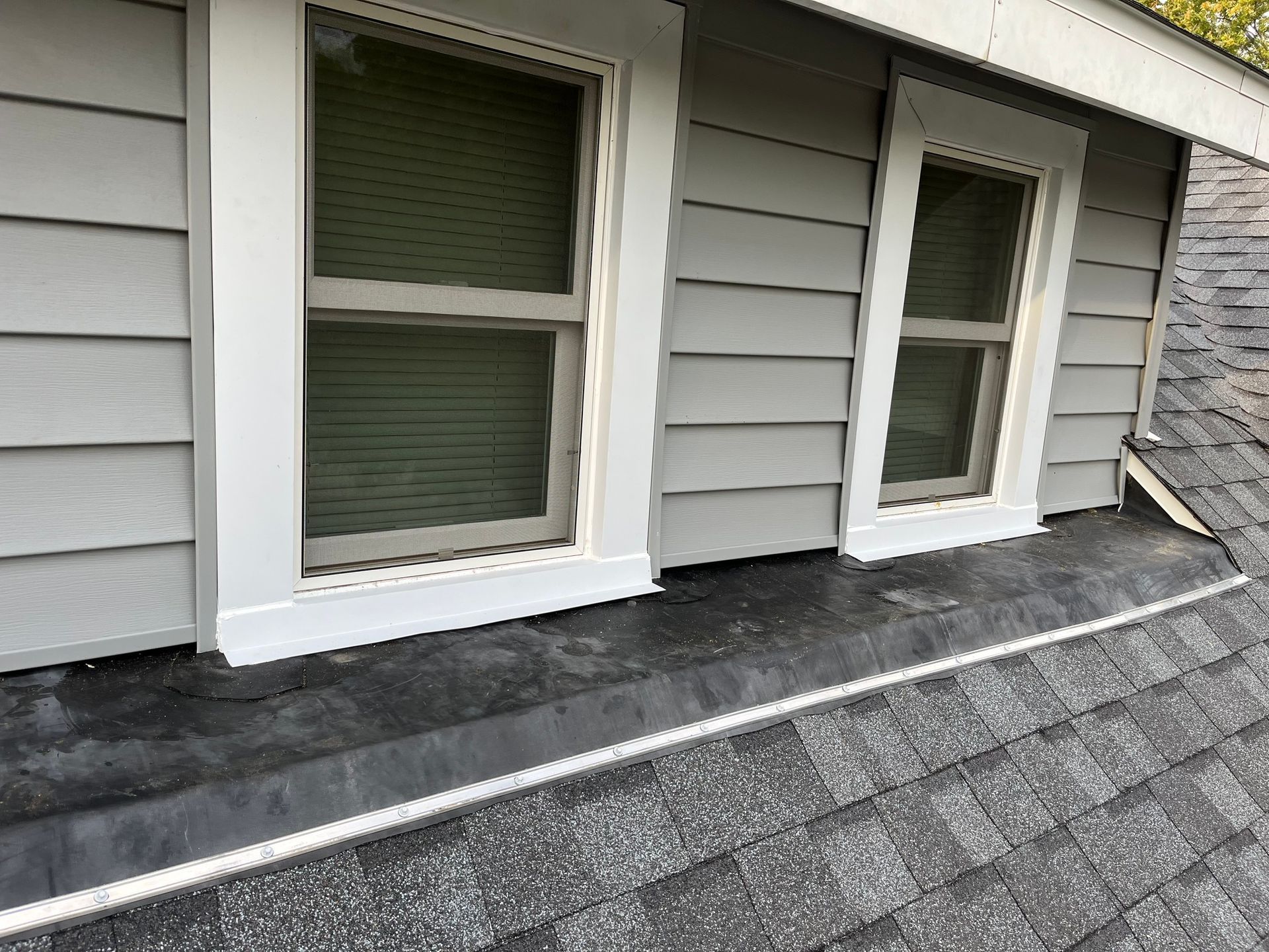 a house with a roof and two windows on it