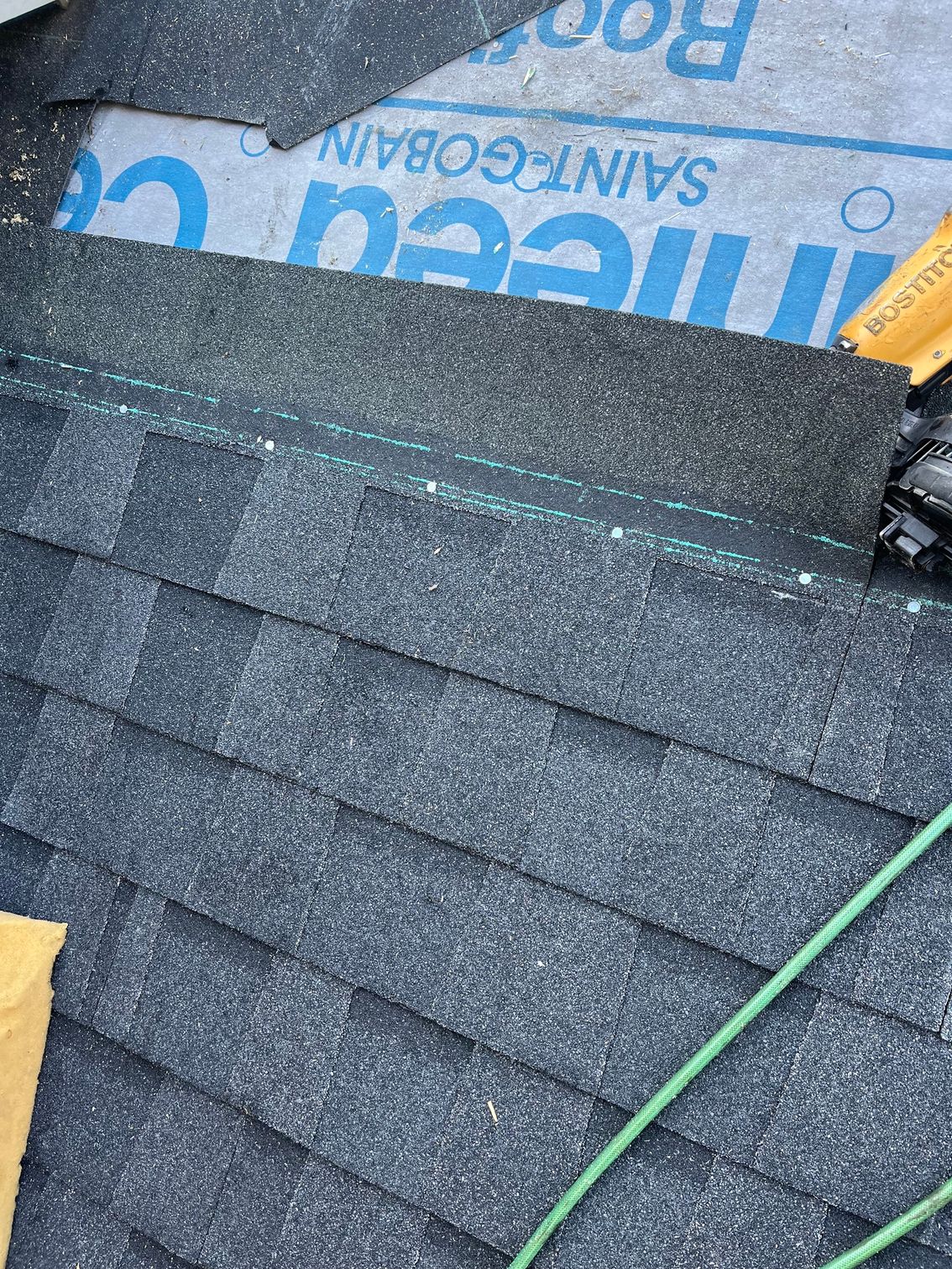 a close up of a roof with shingles being installed