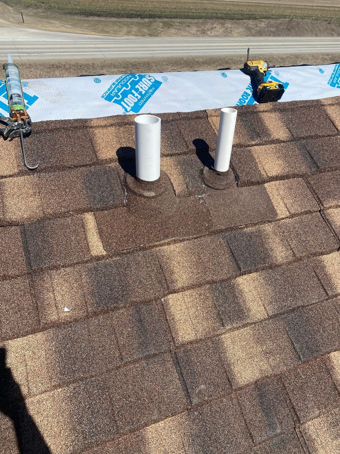 two white pipes are sitting on top of a roof