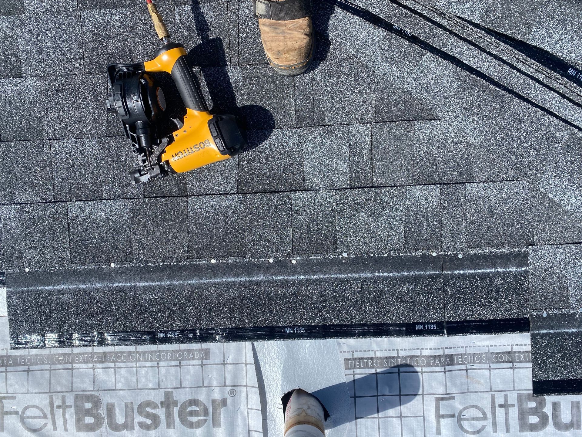 a close up of shingle roofing installation