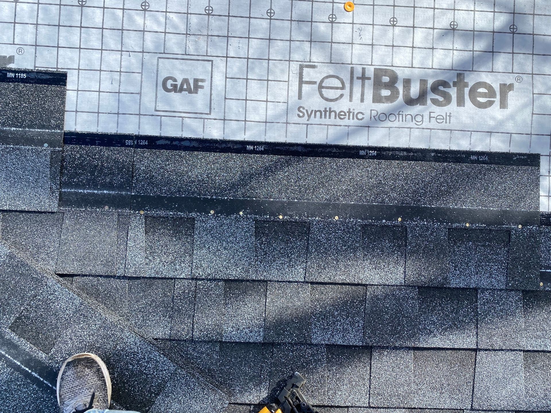 a close up of shingle roofing installation