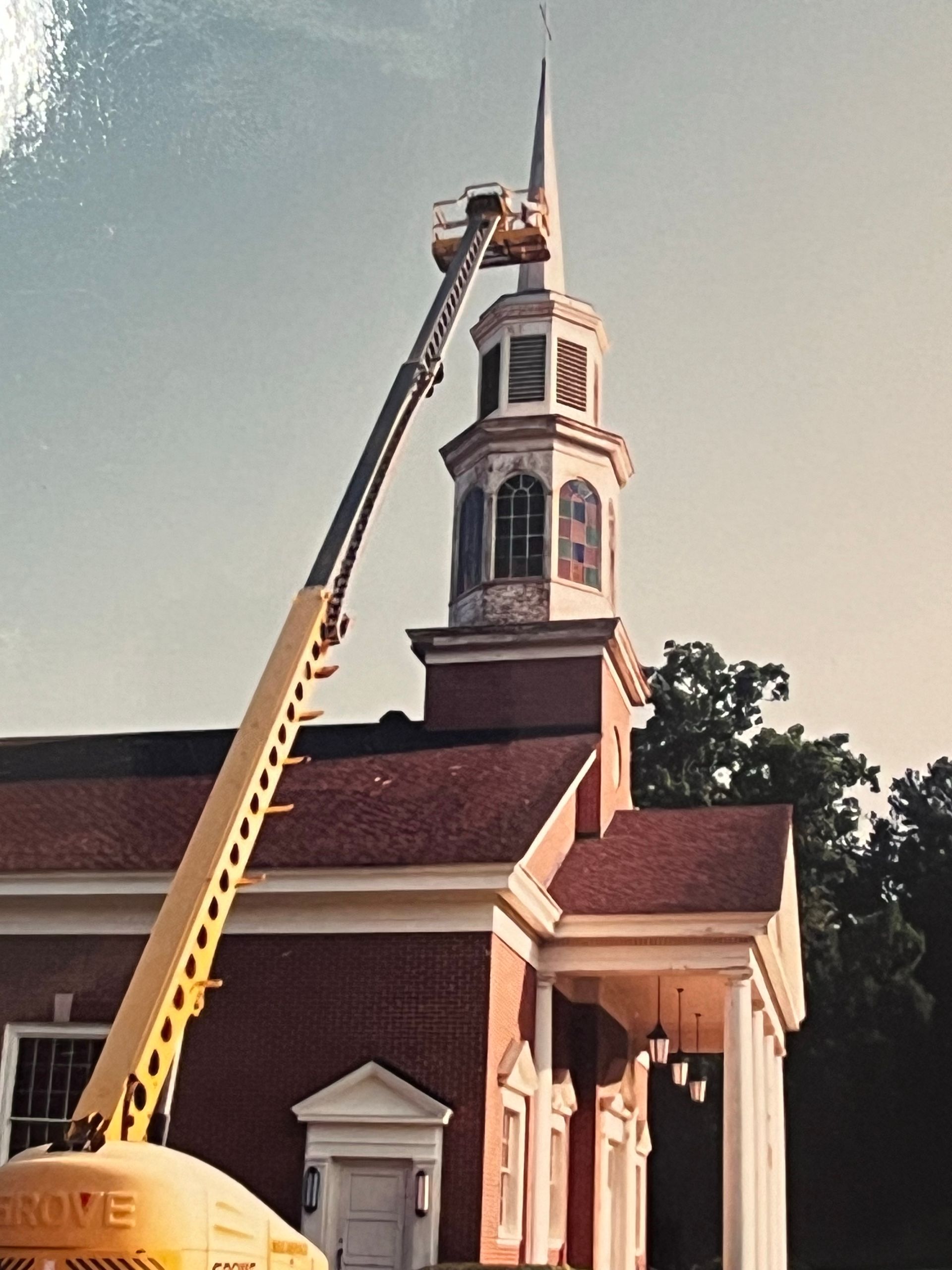 Church steeple being painted