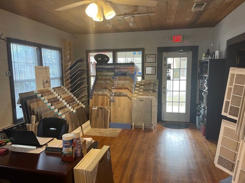 A room filled with lots of wooden floors and a ceiling fan.