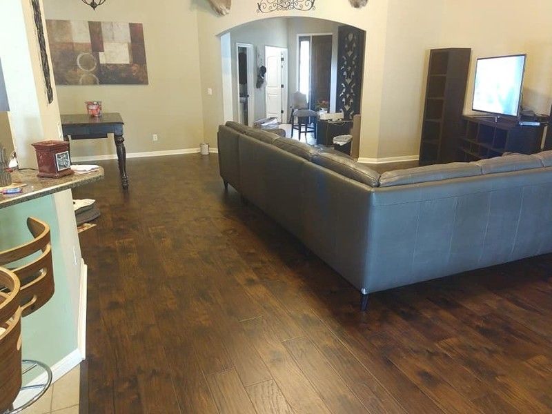 A living room with hardwood floors and a couch.