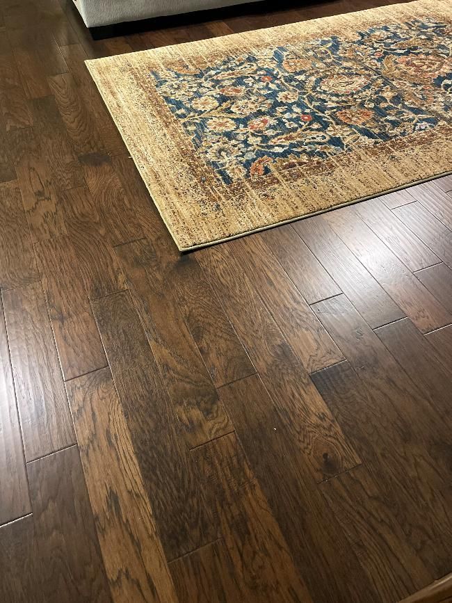 A rug is sitting on a wooden floor next to a rug.