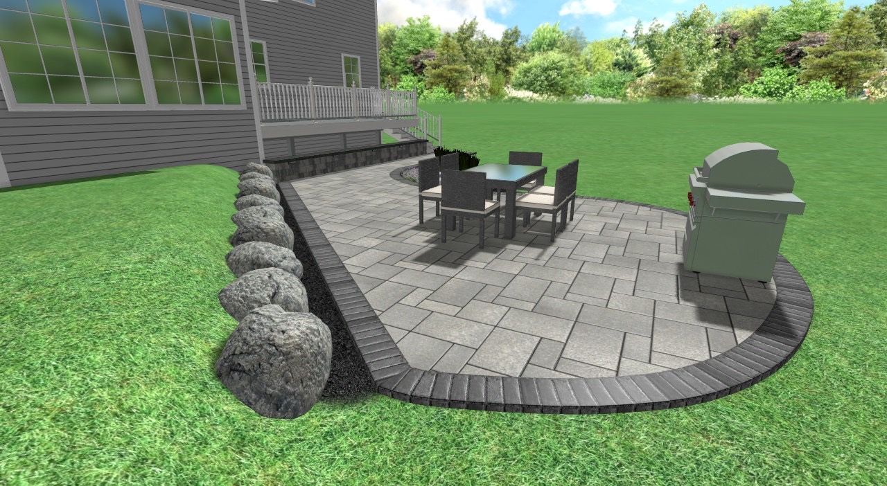 Patio with table, chairs, and grill next to a house with a grassy lawn and landscaping rocks.