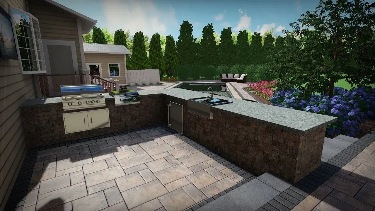Outdoor kitchen with stone pavers, built-in grill, sink, and steps leading to a yard with landscaping.