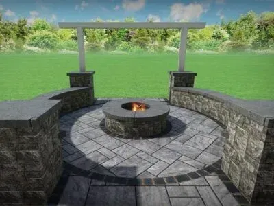Stone patio with fire pit, seating walls, and pergola overlooking a grassy yard.