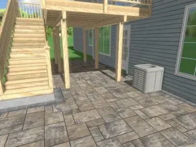 Patio with stone pavers beneath a wooden deck, stairs, and air conditioning unit against a house.