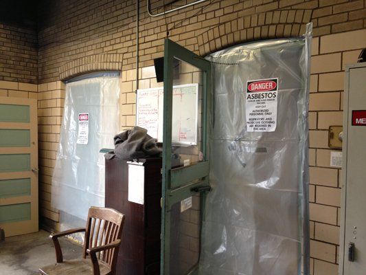 A doorway with plastic sheeting and a 