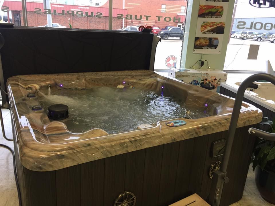 A hot tub is sitting in front of a window in a store.