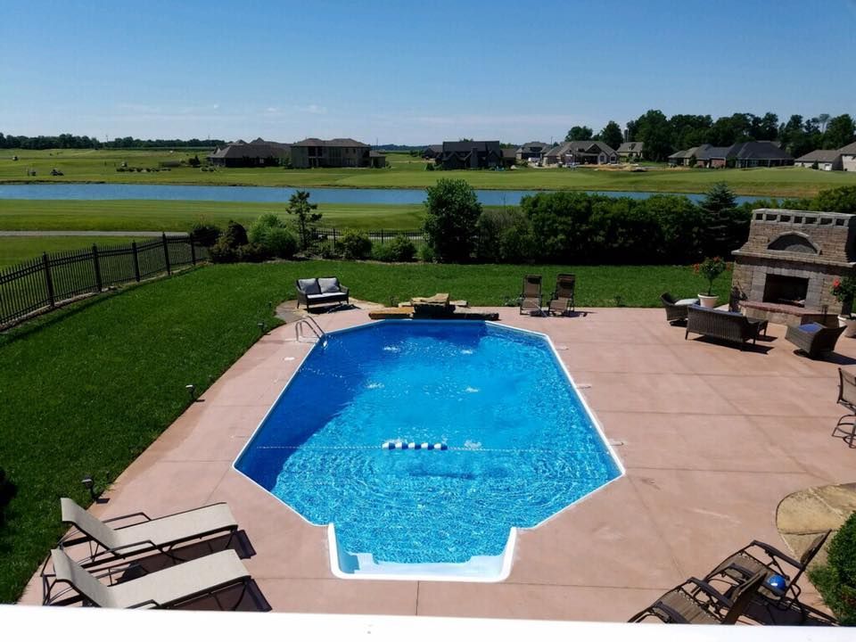 An aerial view of a large swimming pool in a backyard