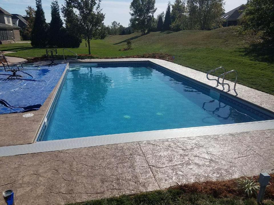 A large swimming pool in the backyard of a house