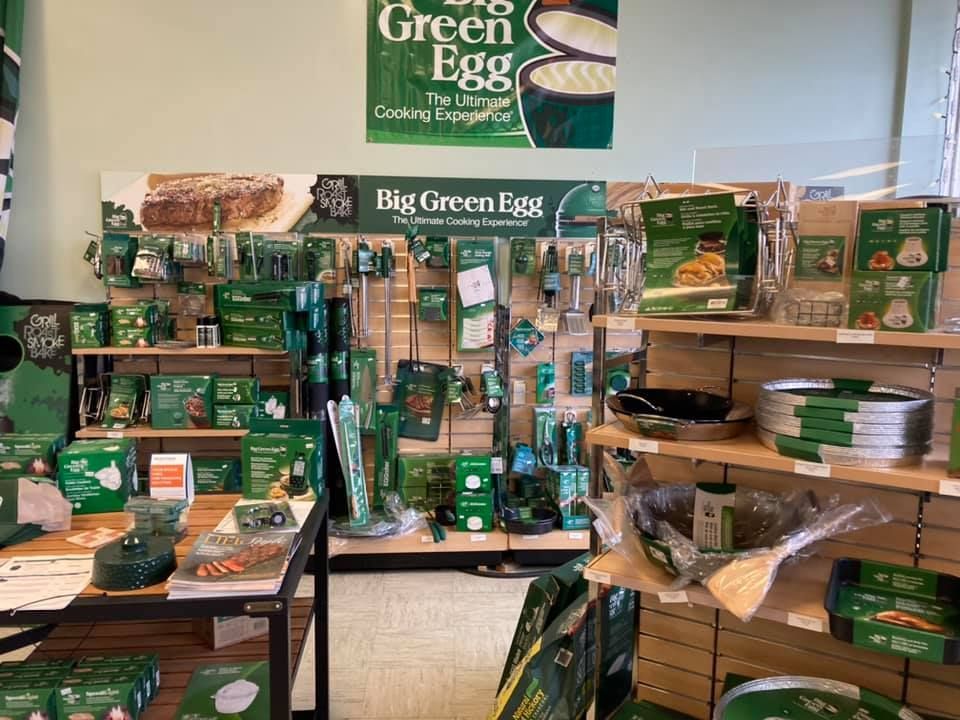 A store filled with lots of green products and a sign that says `` big green egg ''.