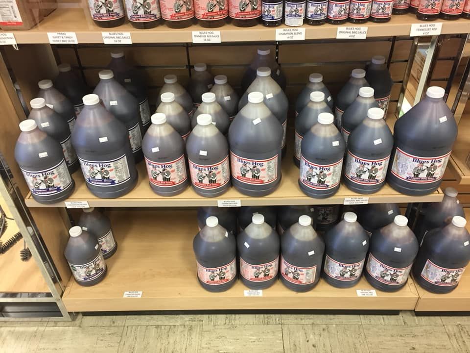 A shelf filled with lots of bottles of liquid on it.
