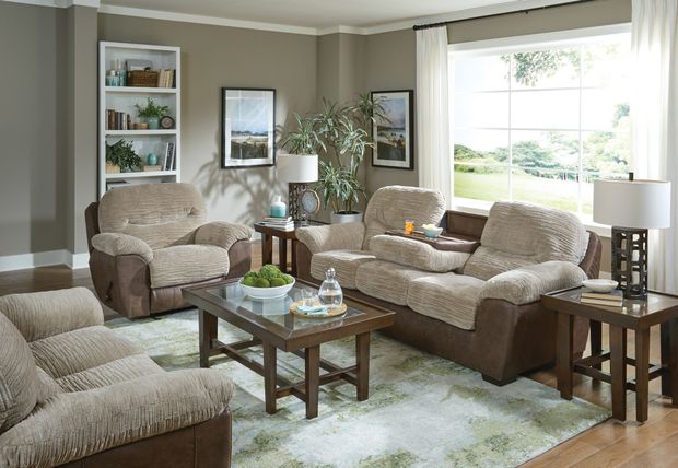 Cozy living room with beige sofas, coffee table, lamps, and a large window with daylight