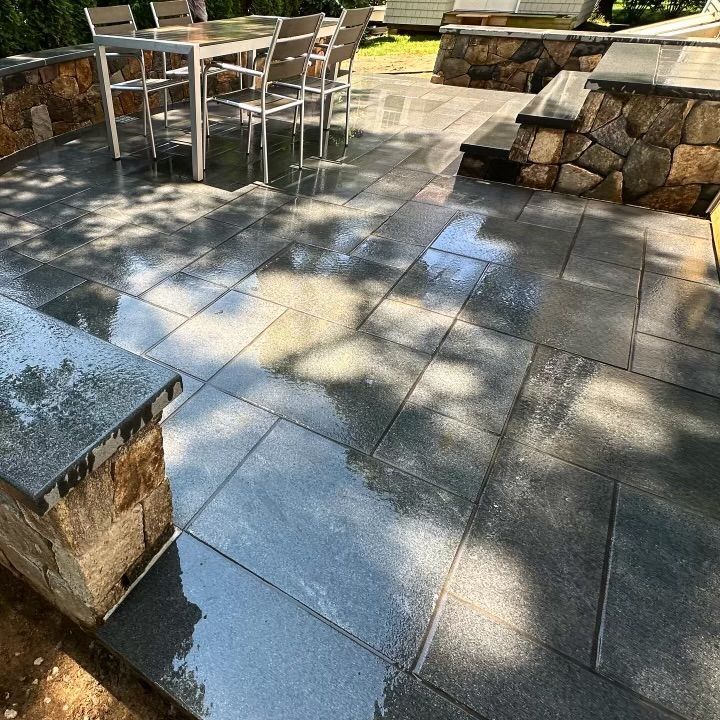 A patio with a table and chairs on it.