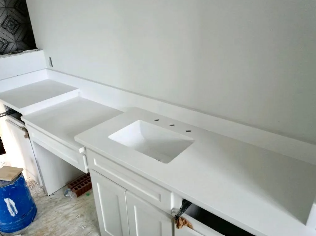 White bathroom vanity countertop with two rectangular sinks and cabinet doors underneath
