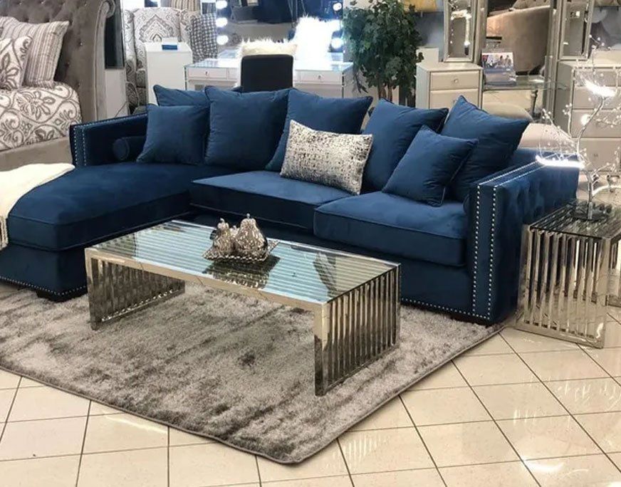 Deep blue sectionals with deep blue throw pillows, chaise, and table