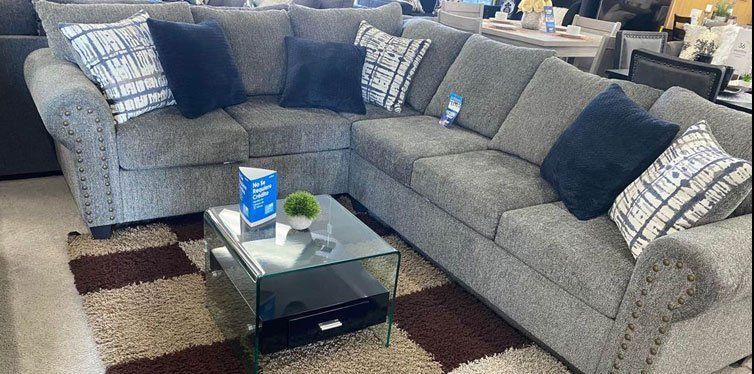 Medium gray sectionals with patterned throw pillows