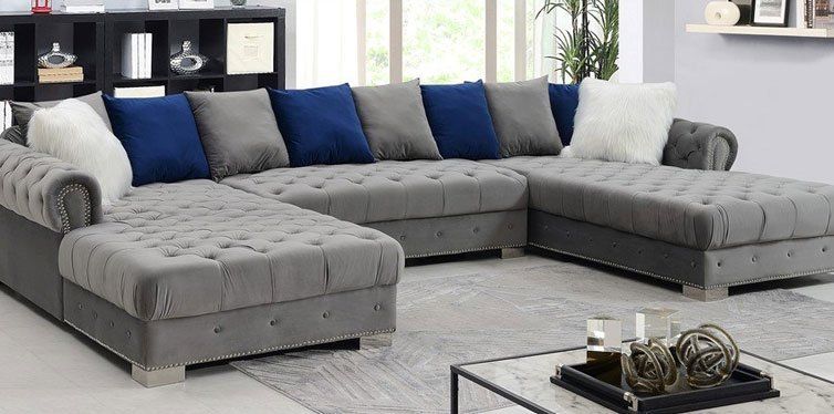 Gray sectionals with blue, gray, and white throw pillows