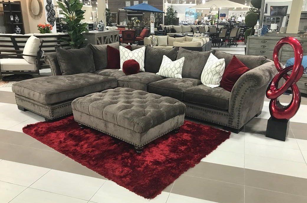 Dark gray fabric sectionals with dark red and white pillows