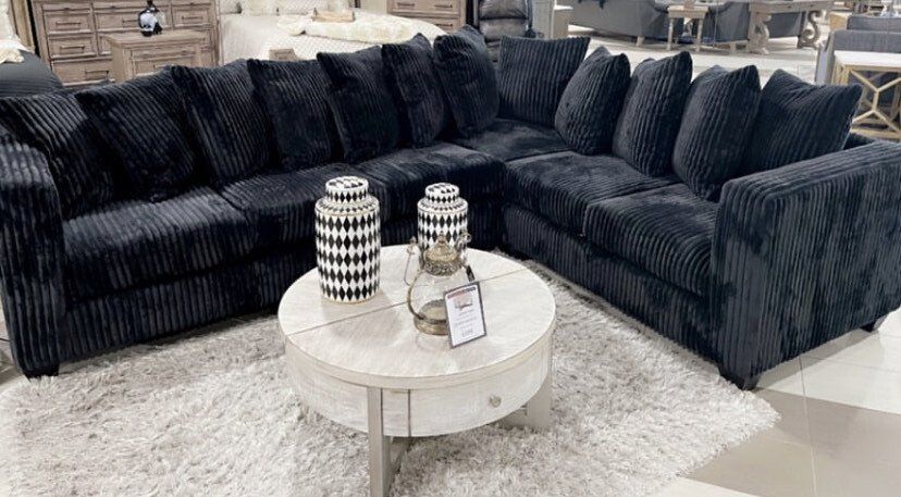 Dark blue fabric sectional with round white table