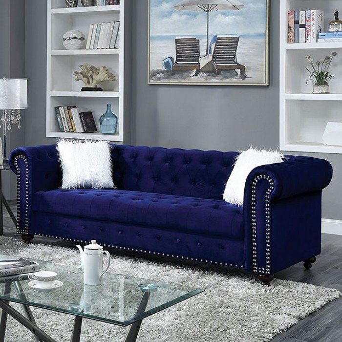Blue sofa with white throw pillows