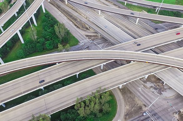 An aerial view of a highway intersection with a lot of traffic.