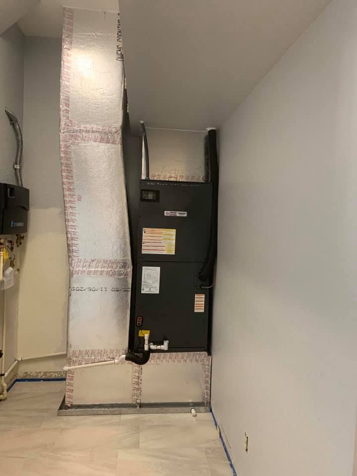 A room with a heater and a chimney in it.