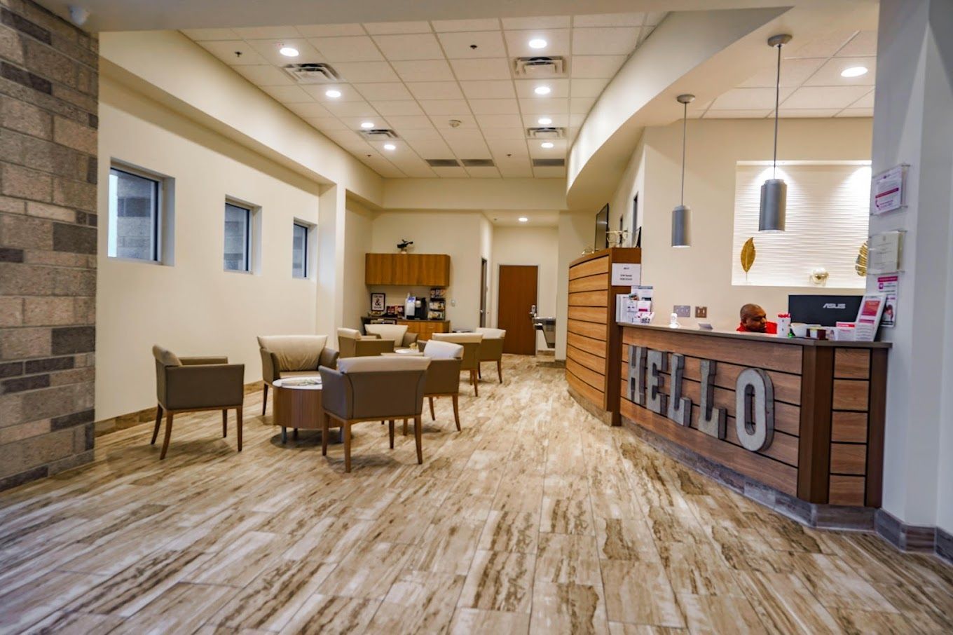 A lobby with a wooden counter that says