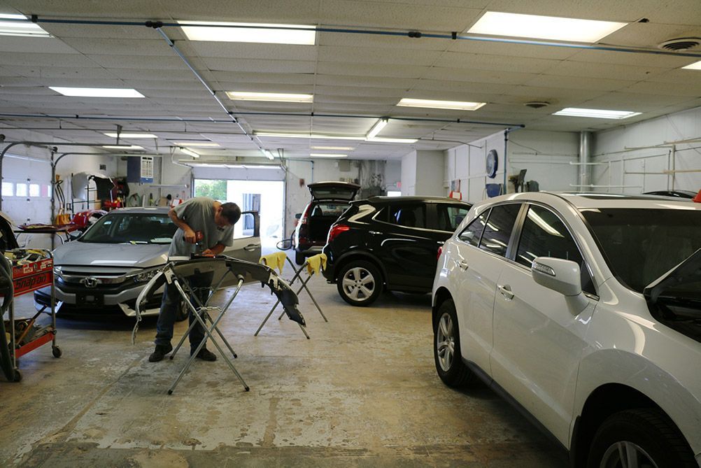A man is working on a car in a garage.