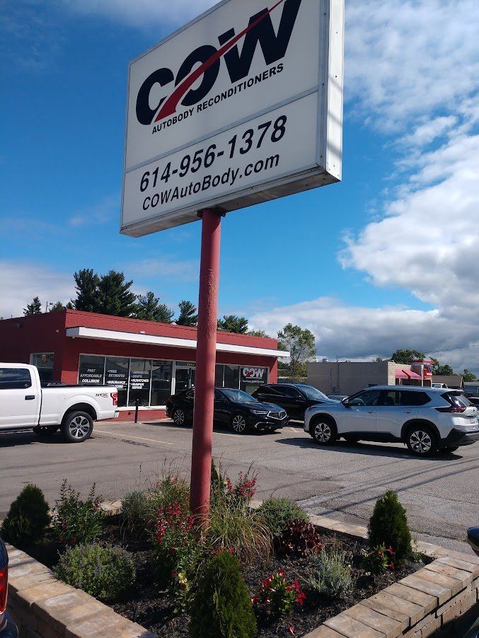 A car dealership with a sign that says cow on it