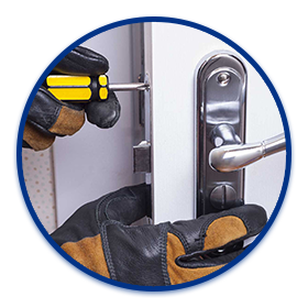 a locksmith is repairing a lock with a screwdriver