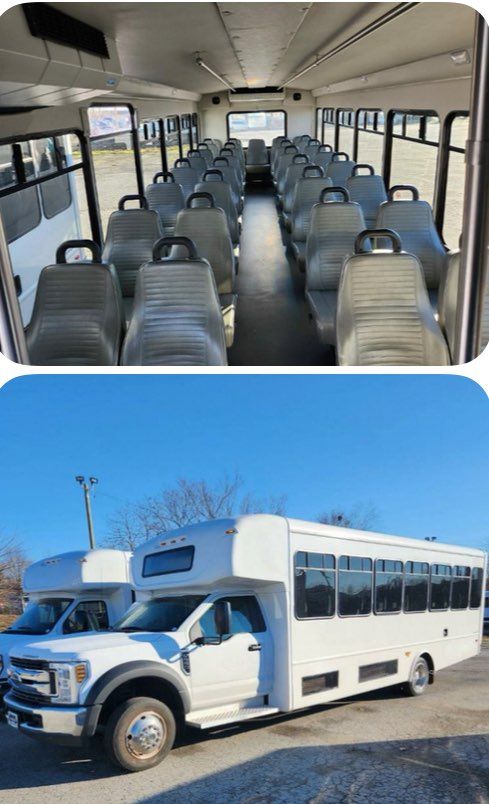 A white bus with a lot of seats is parked in a parking lot.