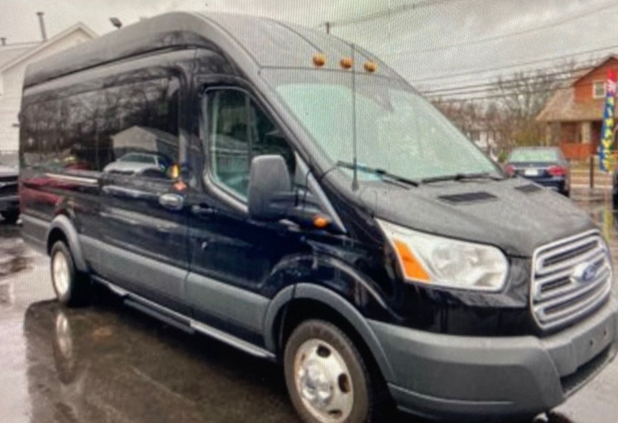A black van is parked in a parking lot.