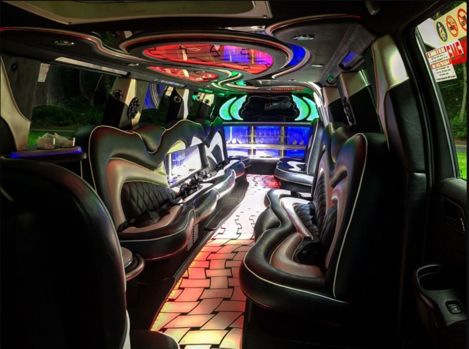 The inside of a limousine with a lot of lights on the ceiling.