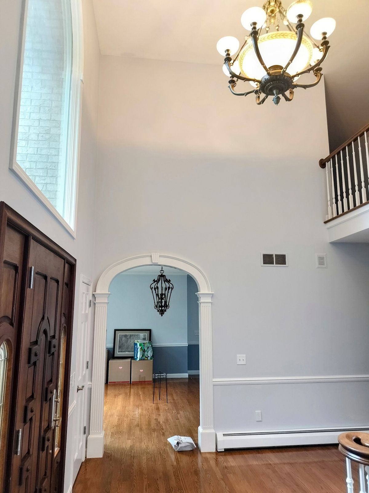 A large hallway with a chandelier hanging from the ceiling